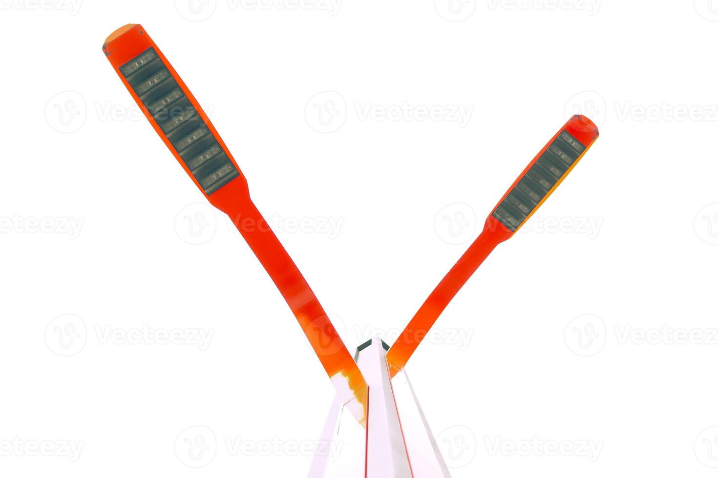 Two bright red street lights positioned in an inverted V shape, high key. photo