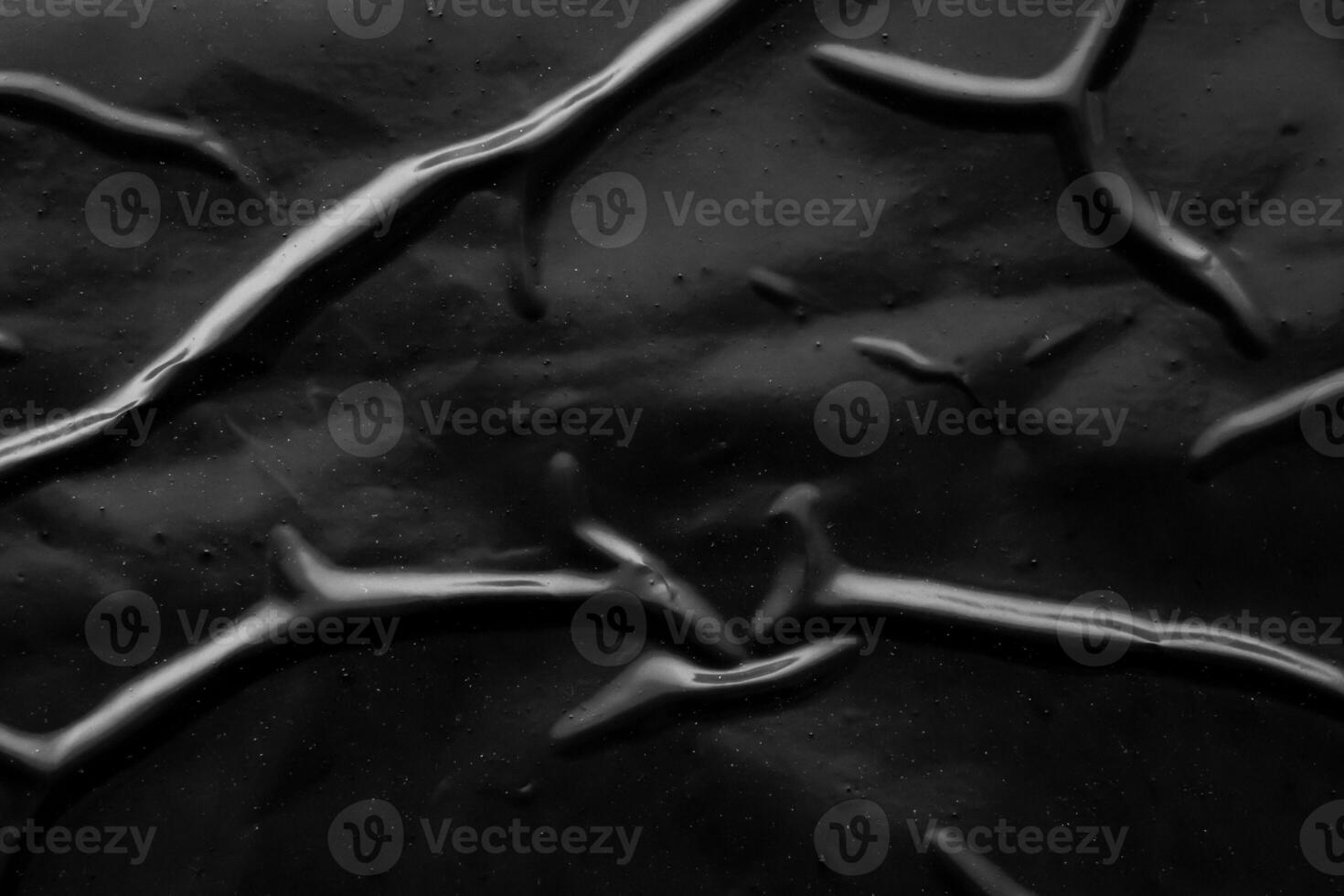 black crumpled and creased plastic poster texture background photo