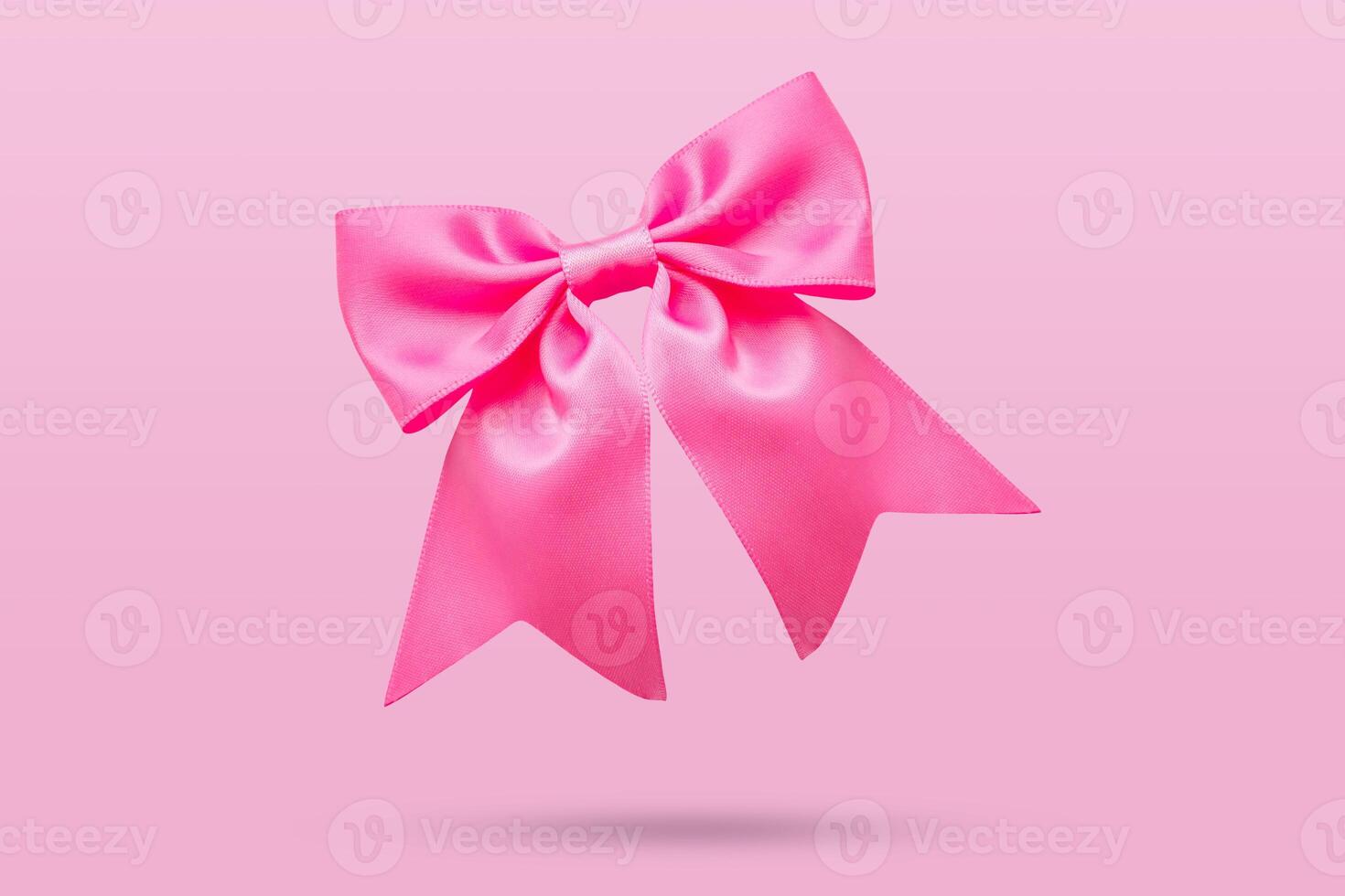 pink gift bow isolated on pink background photo