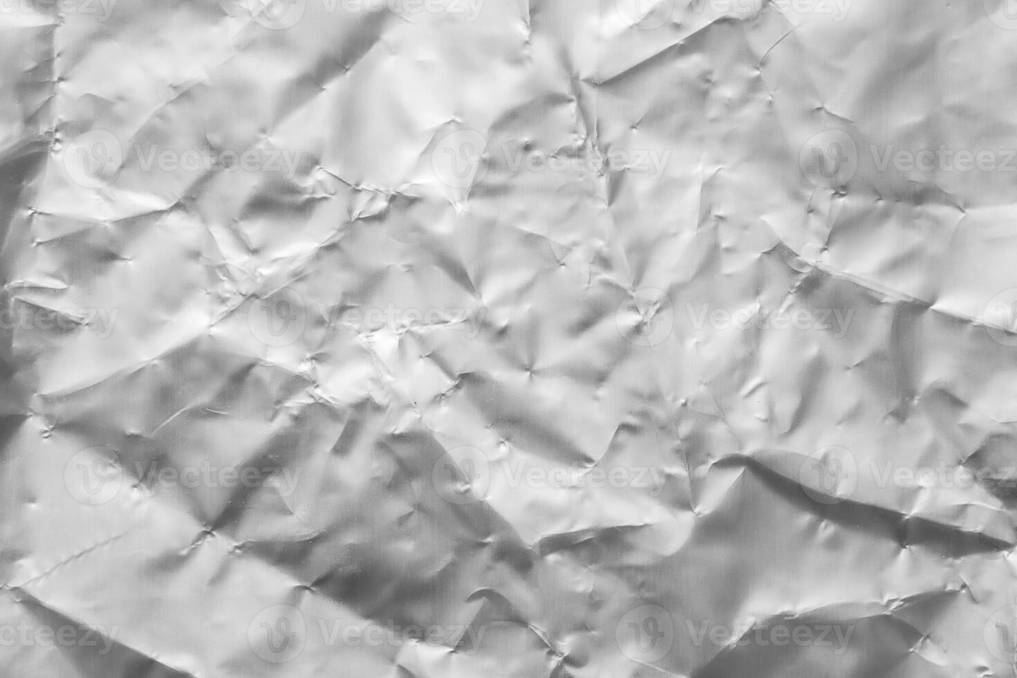 Shiny metal silver gray foil crumpled texture background photo