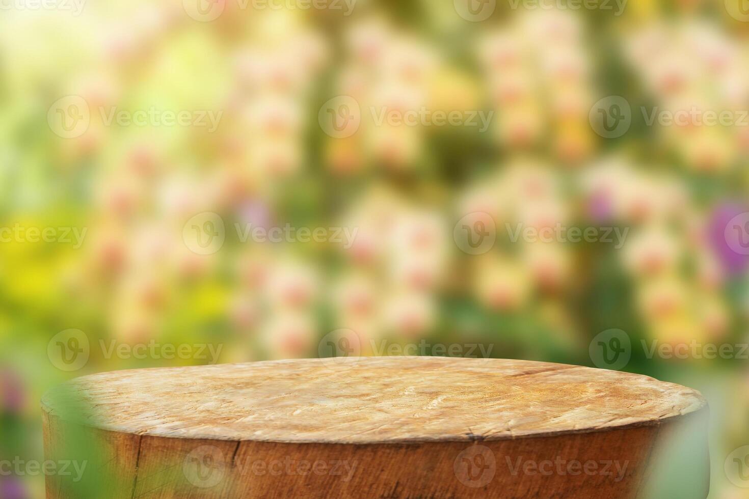 Empty old tree stump table top with blur orchid garden background for product display photo