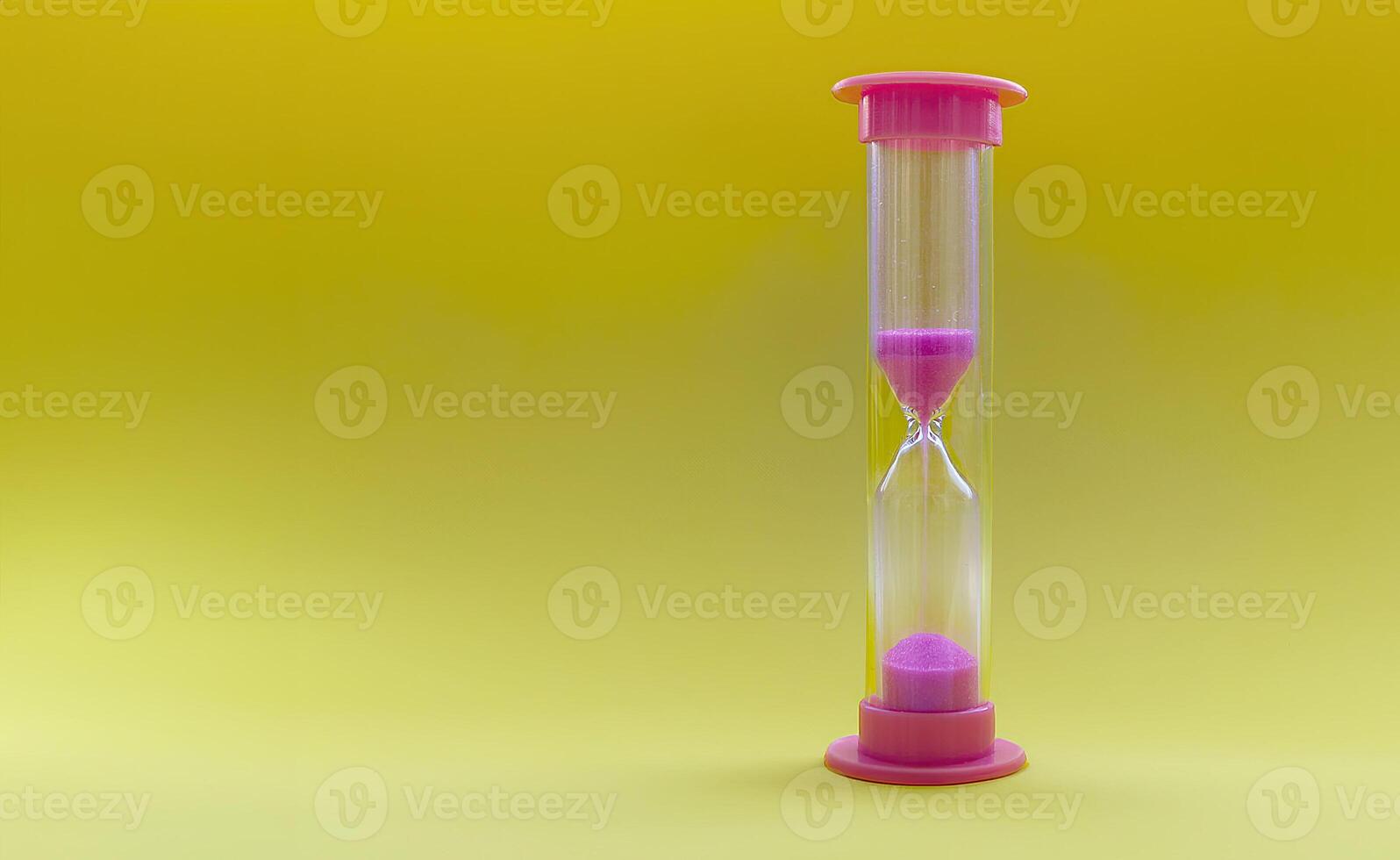 The classic hourglass on a bright yellow background symbolizes the passage of time. The theme of patience, change and the preciousness of moments. Concepts of productivity and mindfulness. photo