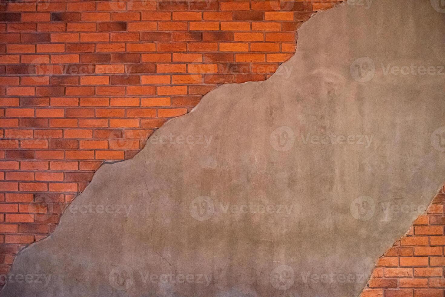 The orange brick background contrasts with the concrete background with a beautiful and vintage pattern. Brick wall contrasts with concrete wall. photo