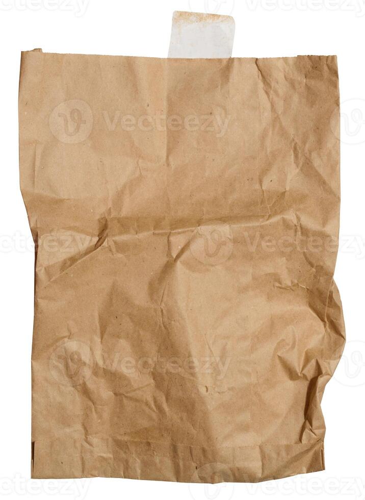 A large empty brown kraft paper bag for packaging products in stores on an isolated background photo