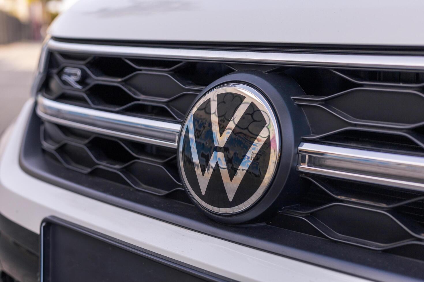 Torrevieja, Spain - 09-07-2024, Close-up of a Volkswagen emblem on a vehicle's grille. VW sign, logo. Ideal for automotive blogs, marketing materials, or discussions on car branding and design. photo