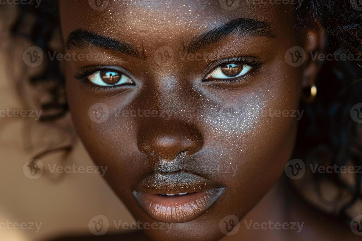 Beautiful young woman with dark skin and curly hair posing in a studio photo