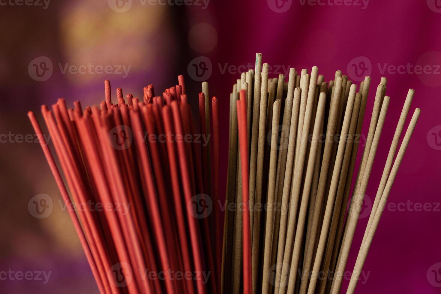 An armful of red incense sticks photo