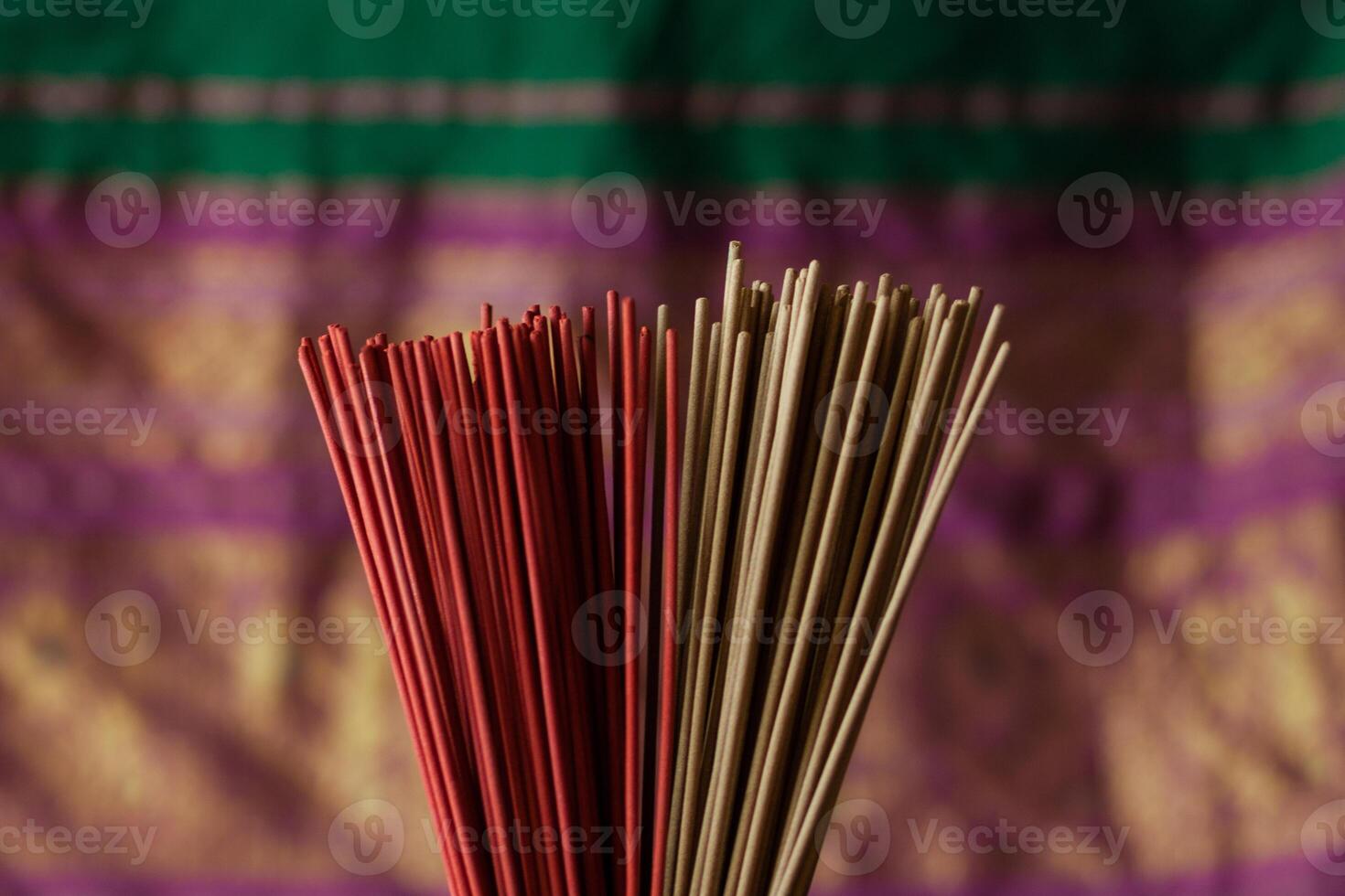 An armful of red incense sticks photo