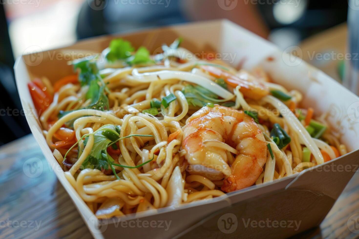 Delicious asian noodles with shrimps and vegetables in take away box photo