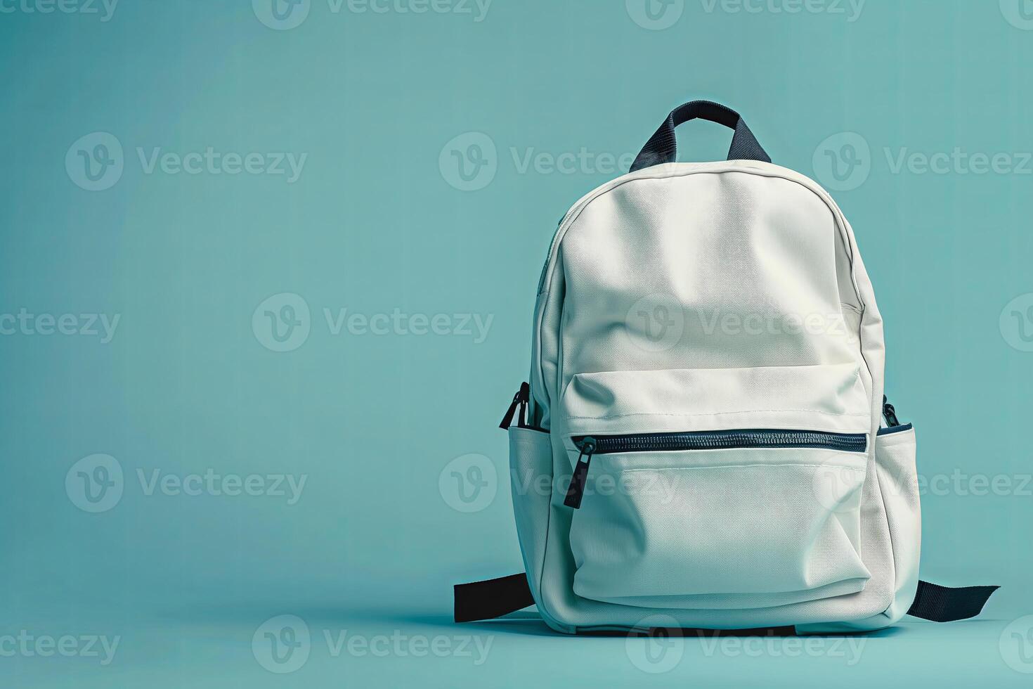 White backpack on a blue background. Back to school concept. Copy space photo