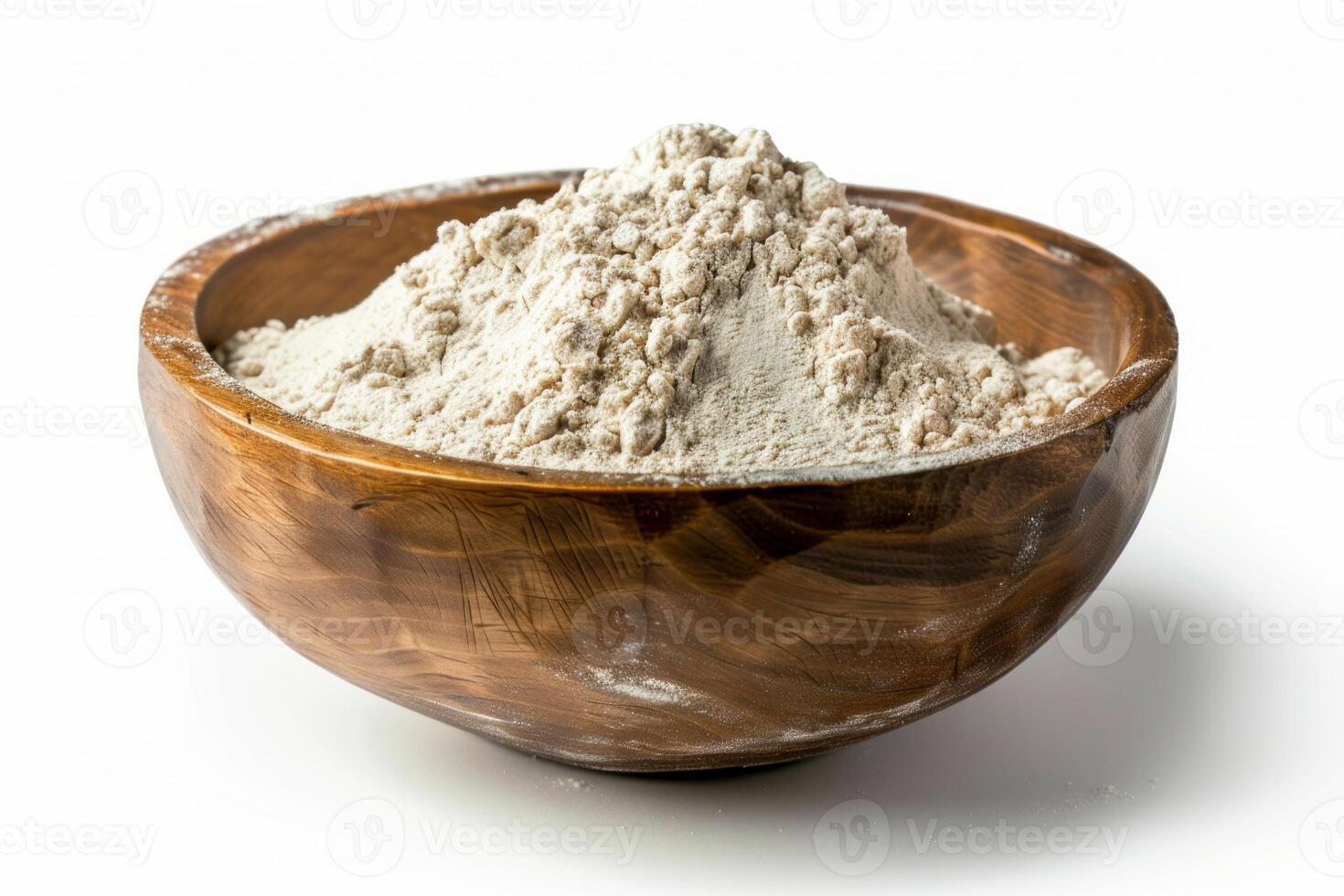 Wooden bowl overflowing with whole wheat flour on white background photo