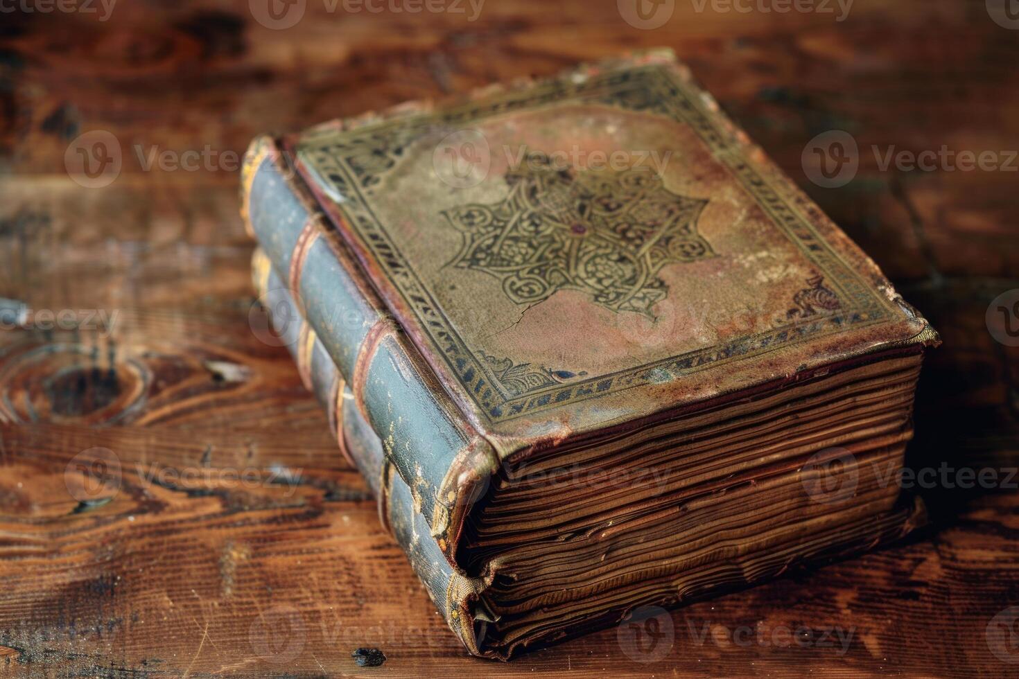 Antique embossed leather book on wooden table photo