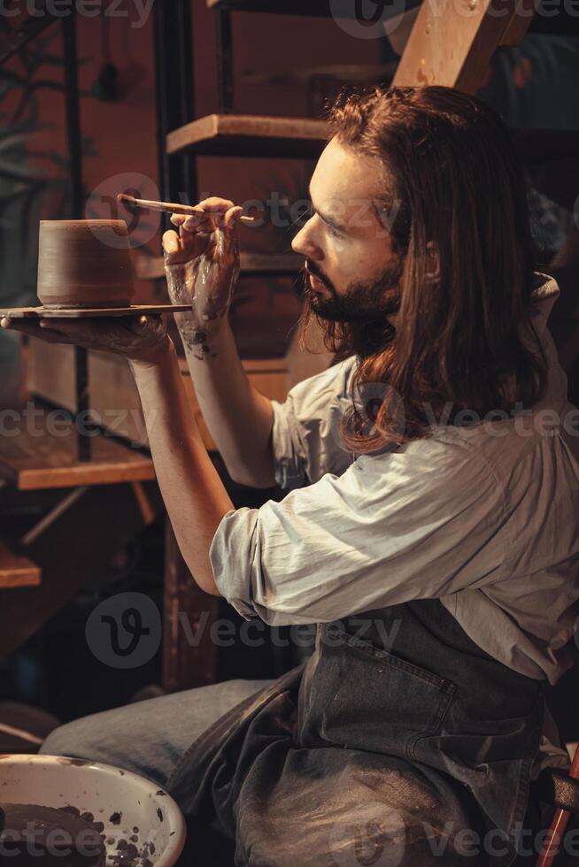 clay cup mug handcrafted man artist happy working proud look at finished hand craft product ceramic tea mug art project at workshop photo