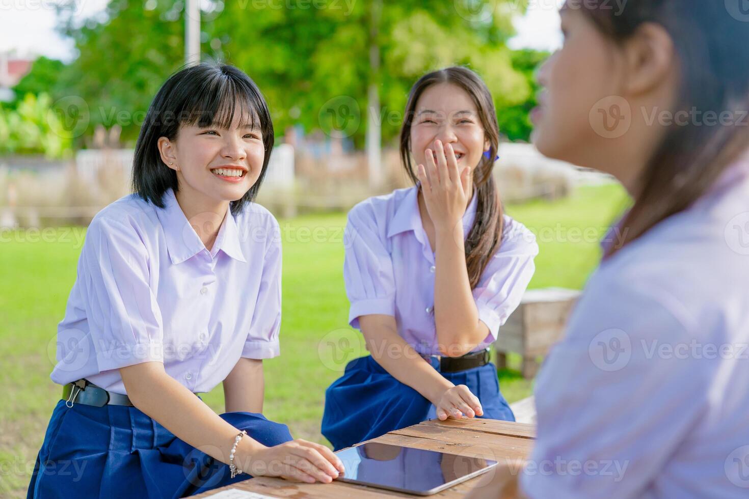 Asian school girls teen friend in school uniform talking leisure together happy laughing at park photo