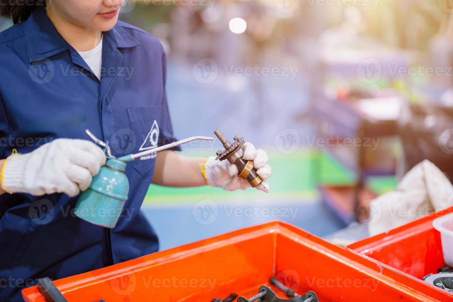 engineer worker cleaning dirty machine part service maintenance engine gear with oil lube photo