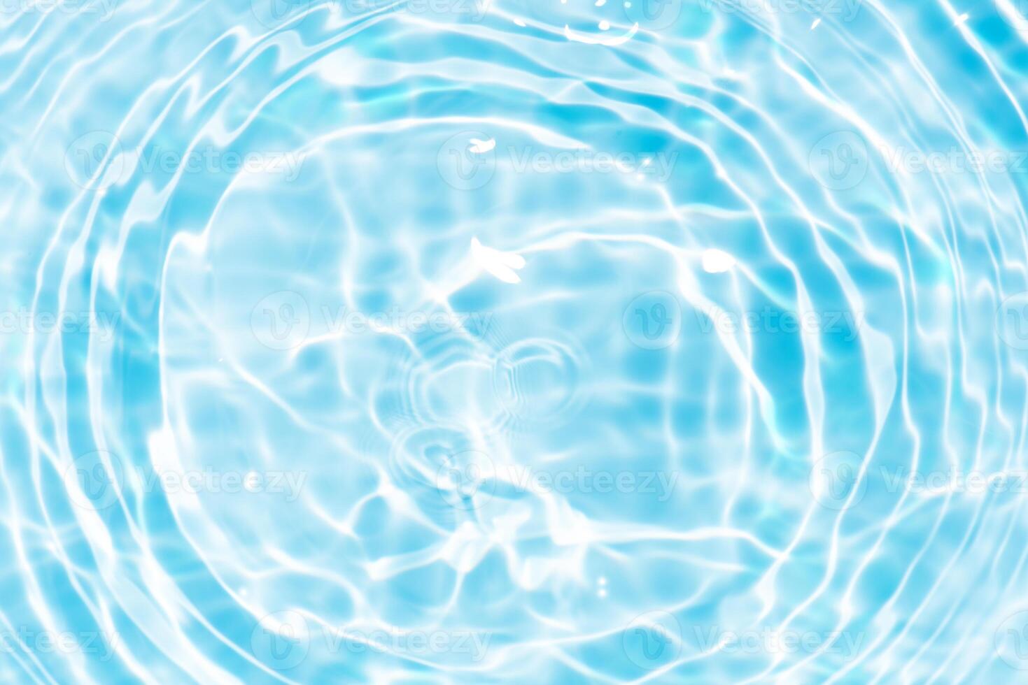 Bluewater waves on the surface ripples blurred. Defocus blurred transparent blue colored clear calm water surface texture with splash and bubbles. Water waves with shining pattern texture background. photo