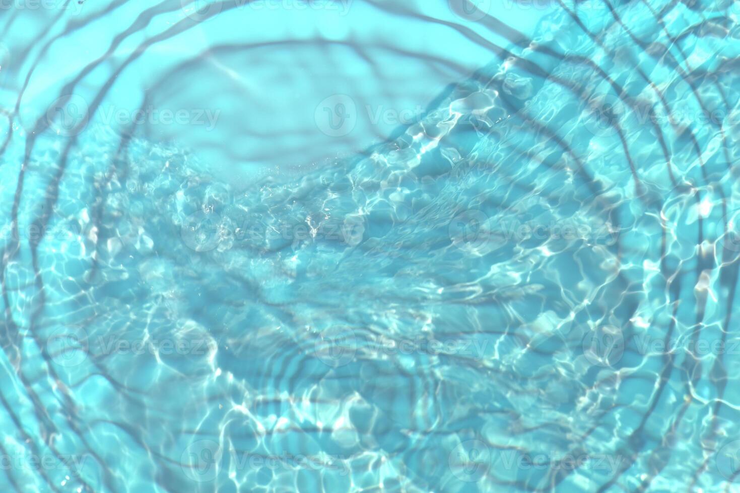 Blue water with ripples on the surface. Defocus blurred transparent blue colored clear calm water surface texture with splashes and bubbles. Water waves with shining pattern texture background. photo