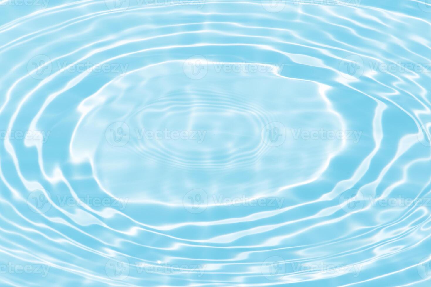 Bluewater waves on the surface ripples blurred. Defocus blurred transparent blue colored clear calm water surface texture with splash and bubbles. Water waves with shining pattern texture background. photo