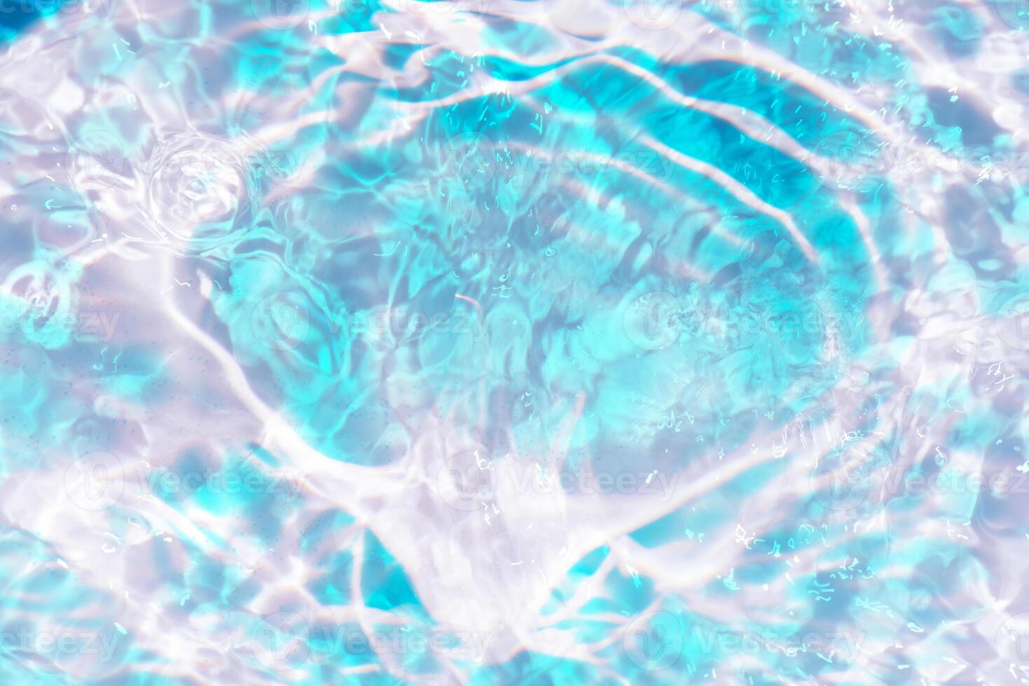 Bluewater waves on the surface ripples blurred. Defocus blurred transparent blue colored clear calm water surface texture with splash and bubbles. Water waves with shining pattern texture background. photo