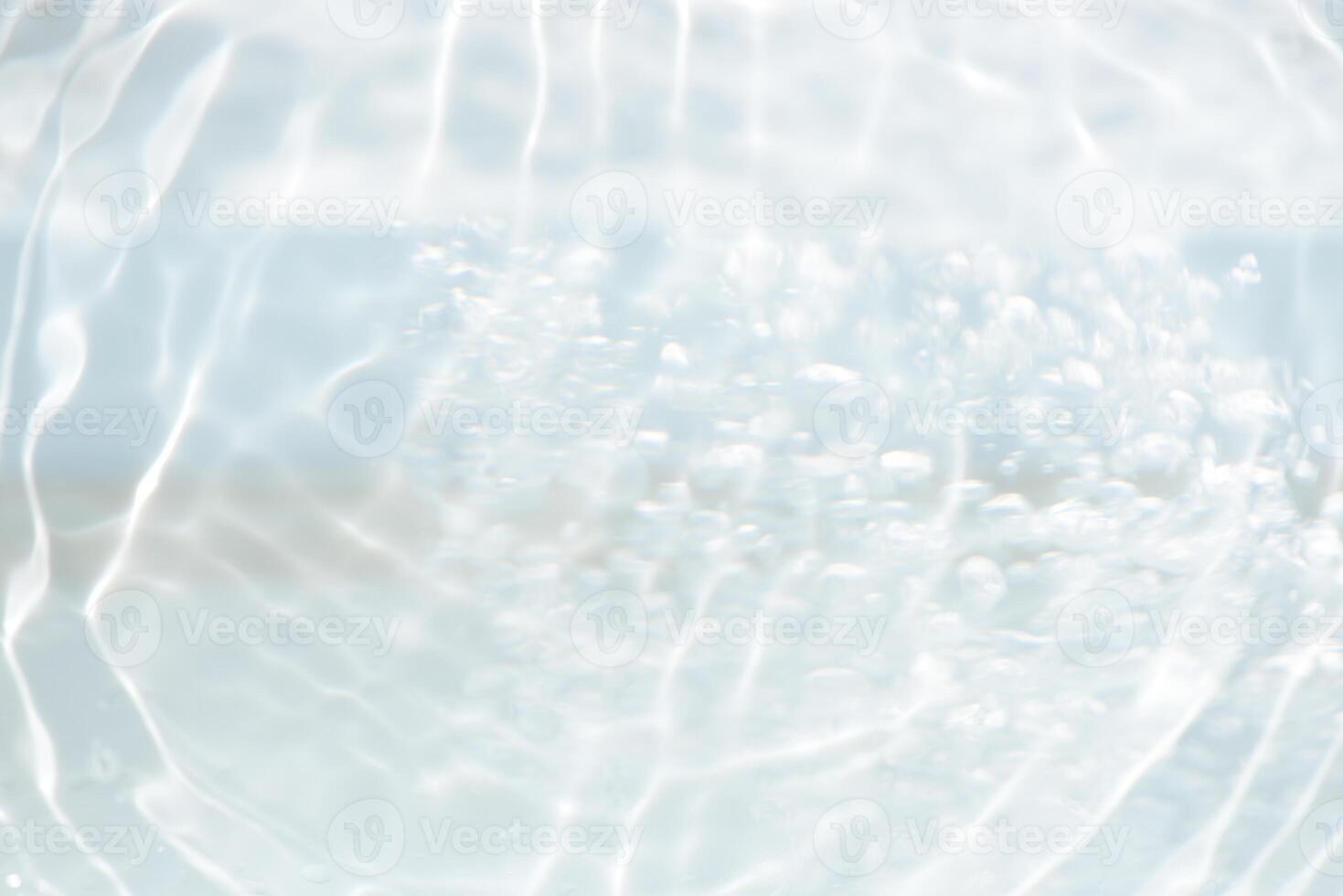 Bluewater waves on the surface ripples blurred. Defocus blurred transparent blue colored clear calm water surface texture with splash and bubbles. Water waves with shining pattern texture background. photo