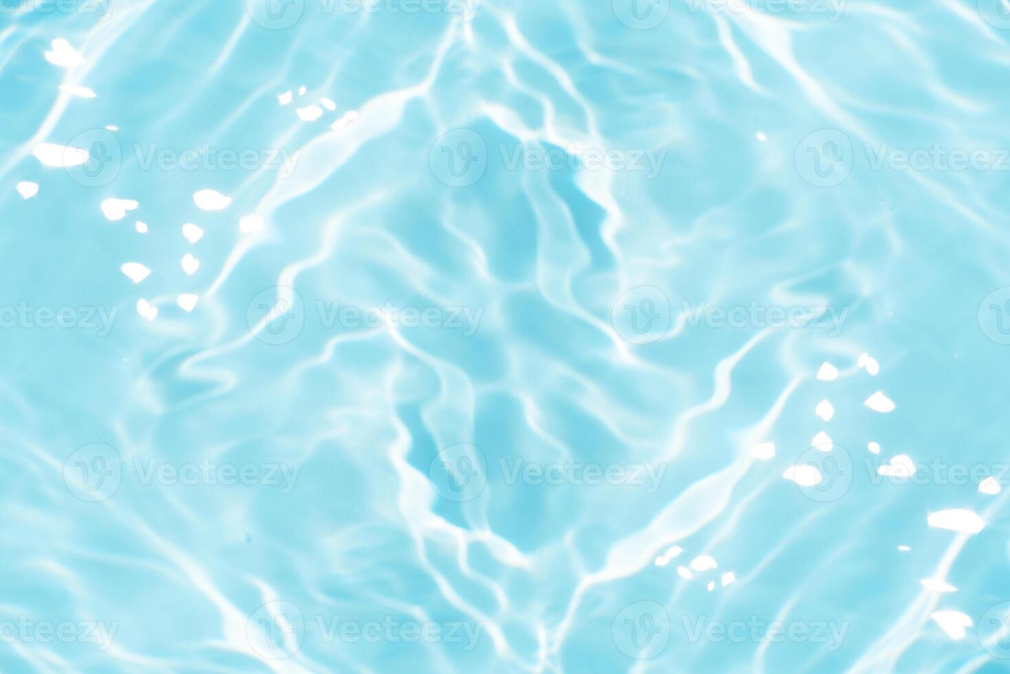 Bluewater waves on the surface ripples blurred. Defocus blurred transparent blue colored clear calm water surface texture with splash and bubbles. Water waves with shining pattern texture background. photo