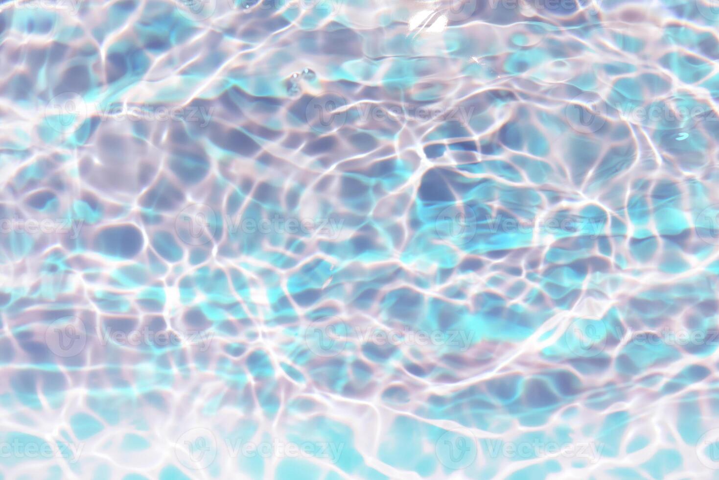Bluewater waves on the surface ripples blurred. Defocus blurred transparent blue colored clear calm water surface texture with splash and bubbles. Water waves with shining pattern texture background. photo