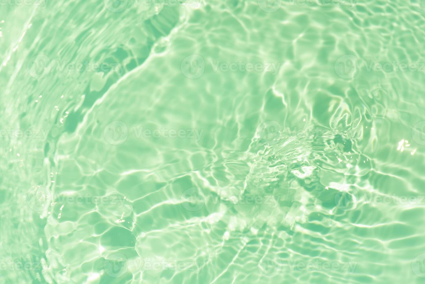Bluewater waves on the surface ripples blurred. Defocus blurred transparent blue colored clear calm water surface texture with splash and bubbles. Water waves with shining pattern texture background. photo