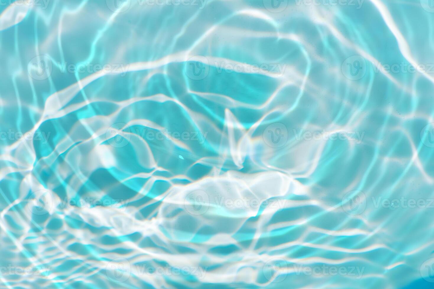 Bluewater waves on the surface ripples blurred. Defocus blurred transparent blue colored clear calm water surface texture with splash and bubbles. Water waves with shining pattern texture background. photo