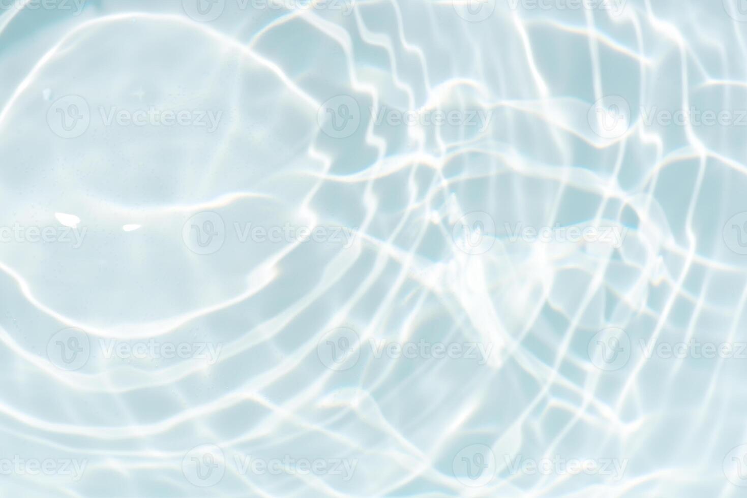 Bluewater waves on the surface ripples blurred. Defocus blurred transparent blue colored clear calm water surface texture with splash and bubbles. Water waves with shining pattern texture background. photo
