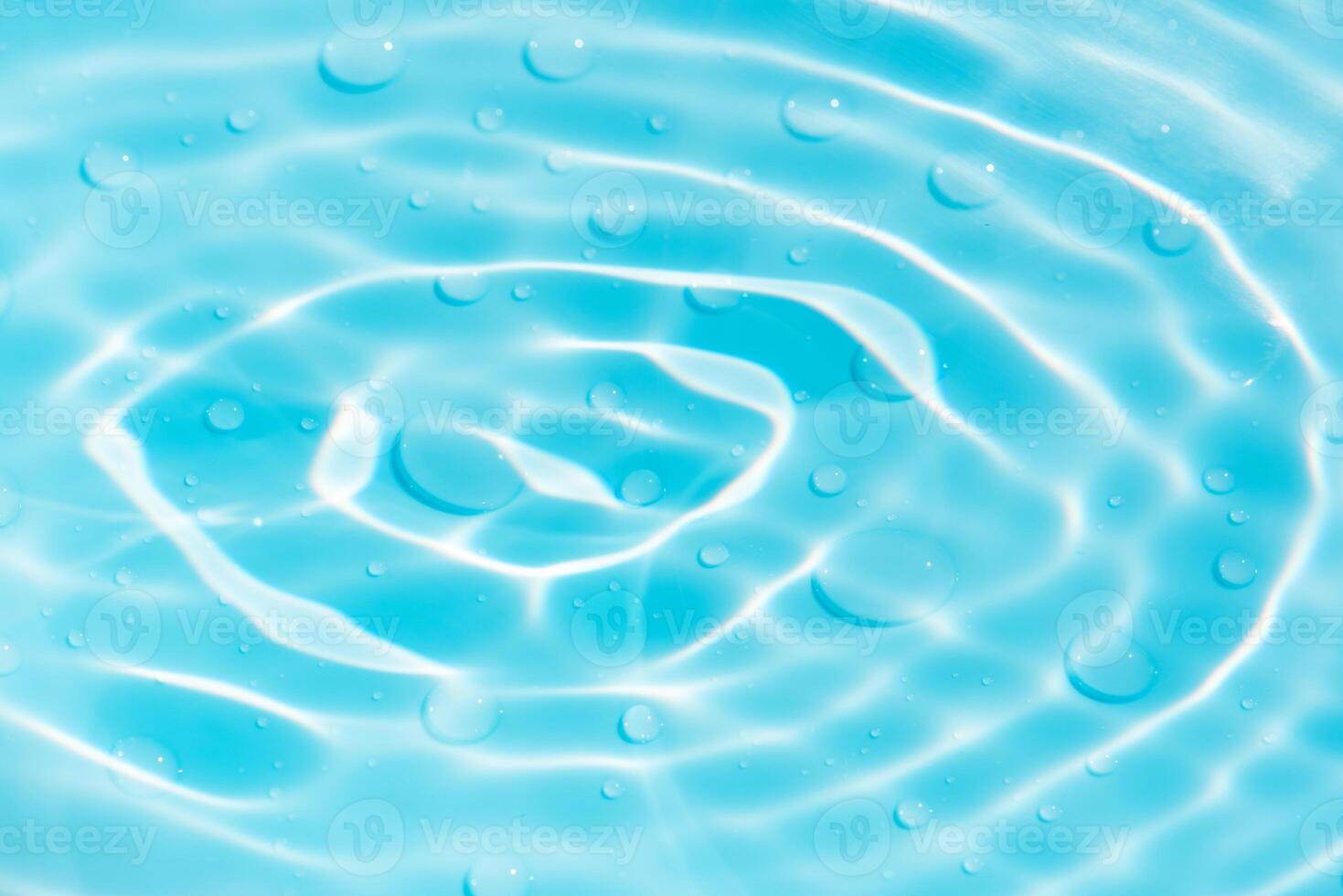 Bluewater waves on the surface ripples blurred. Defocus blurred transparent blue colored clear calm water surface texture with splash and bubbles. Water waves with shining pattern texture background. photo