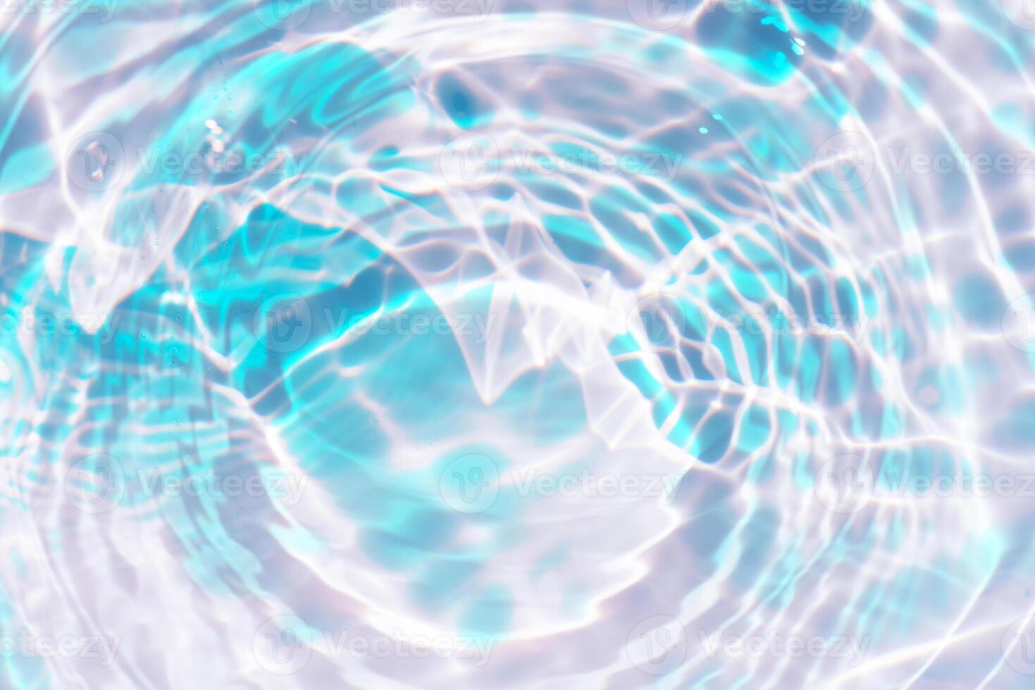 Bluewater waves on the surface ripples blurred. Defocus blurred transparent blue colored clear calm water surface texture with splash and bubbles. Water waves with shining pattern texture background. photo