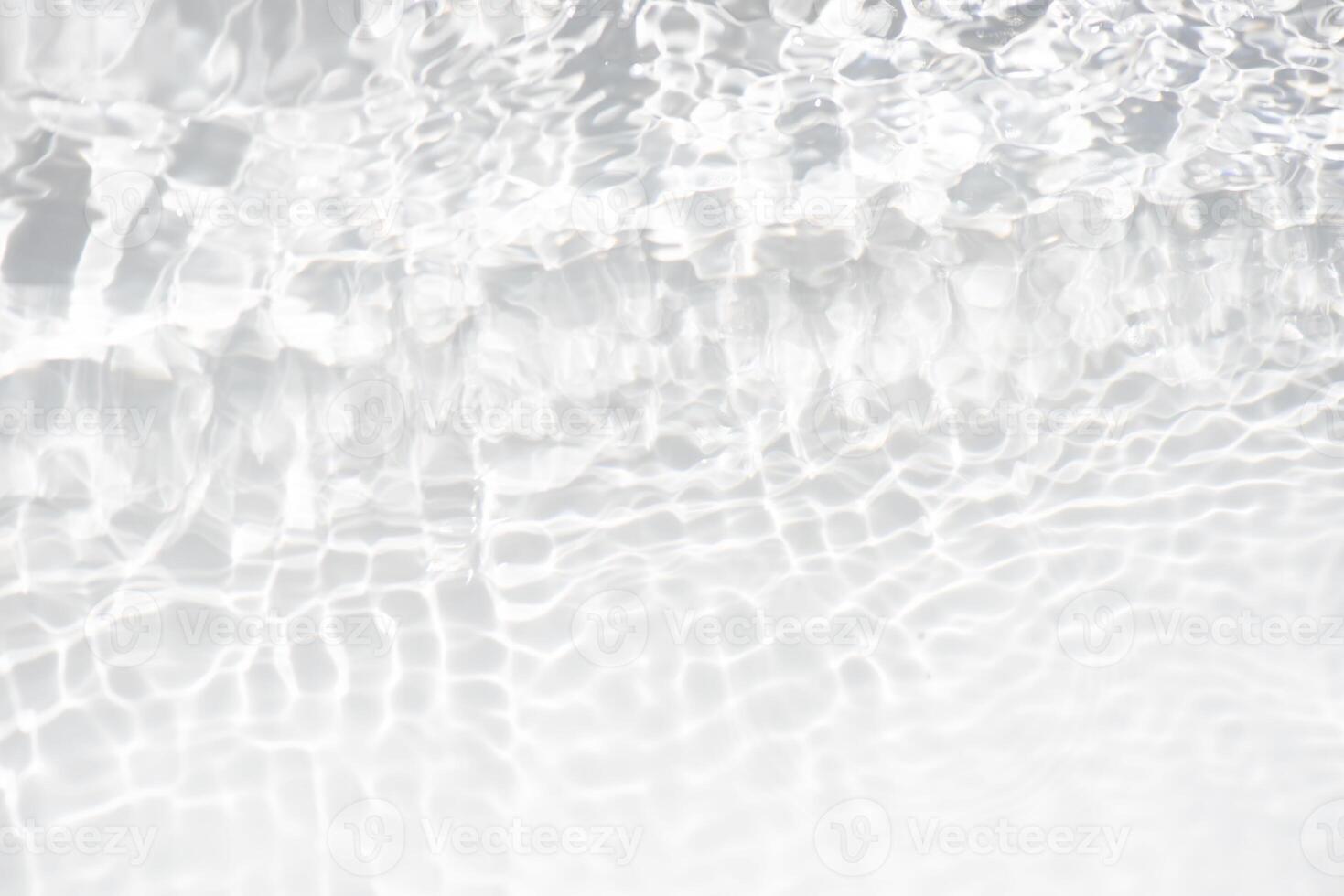 Bluewater waves on the surface ripples blurred. Defocus blurred transparent blue colored clear calm water surface texture with splash and bubbles. Water waves with shining pattern texture background. photo