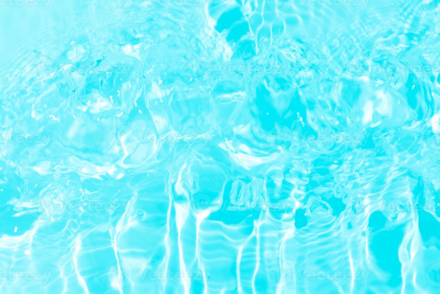 Blue water with ripples on the surface. Defocus blurred transparent blue colored clear calm water surface texture with splashes and bubbles. Water waves with shining pattern texture background. photo