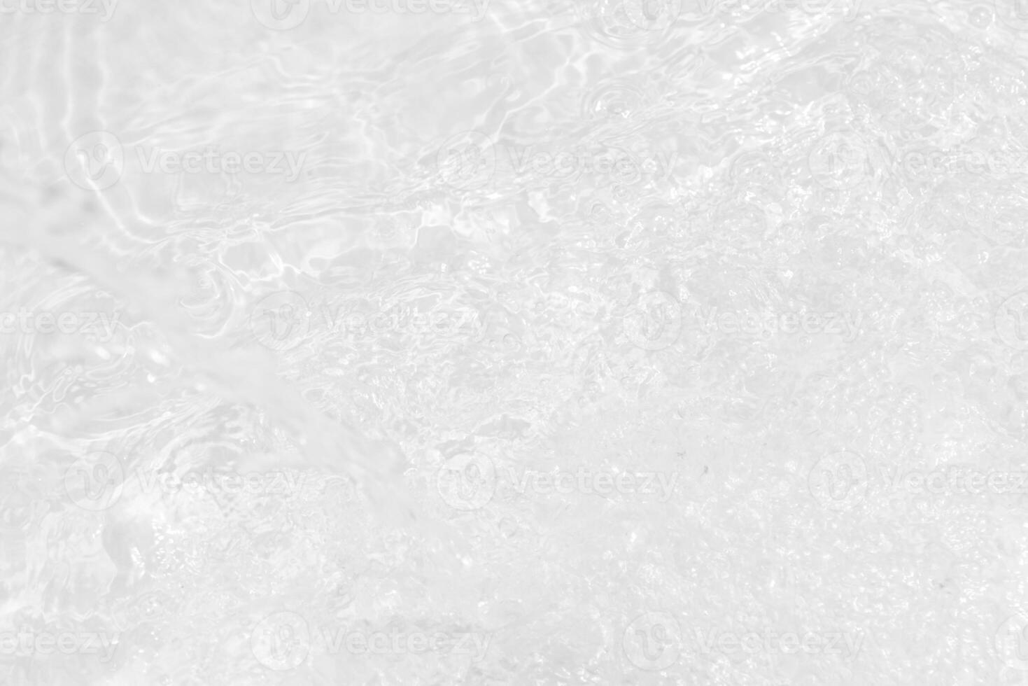 Bluewater waves on the surface ripples blurred. Defocus blurred transparent blue colored clear calm water surface texture with splash and bubbles. Water waves with shining pattern texture background. photo