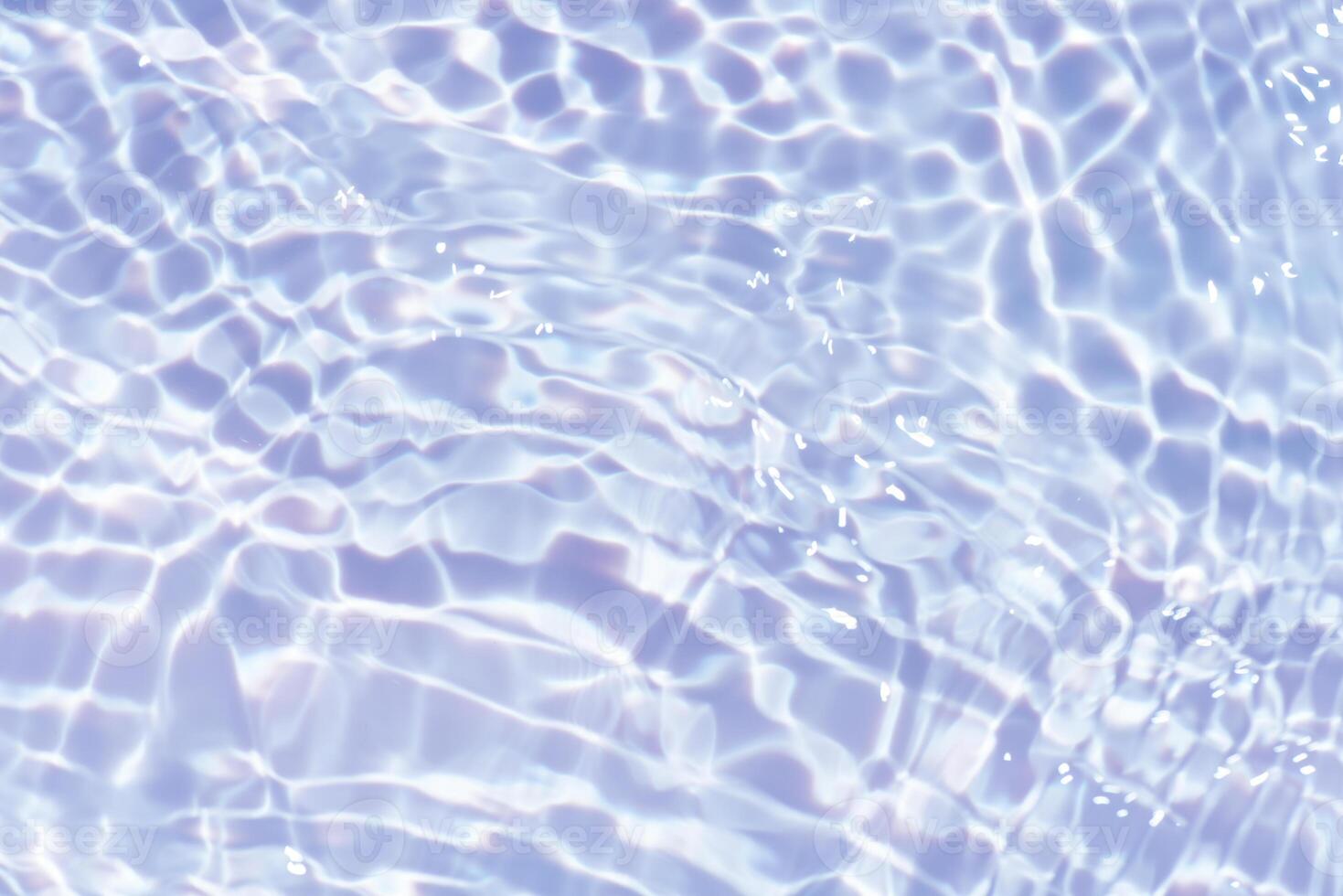 Bluewater waves on the surface ripples blurred. Defocus blurred transparent blue colored clear calm water surface texture with splash and bubbles. Water waves with shining pattern texture background. photo