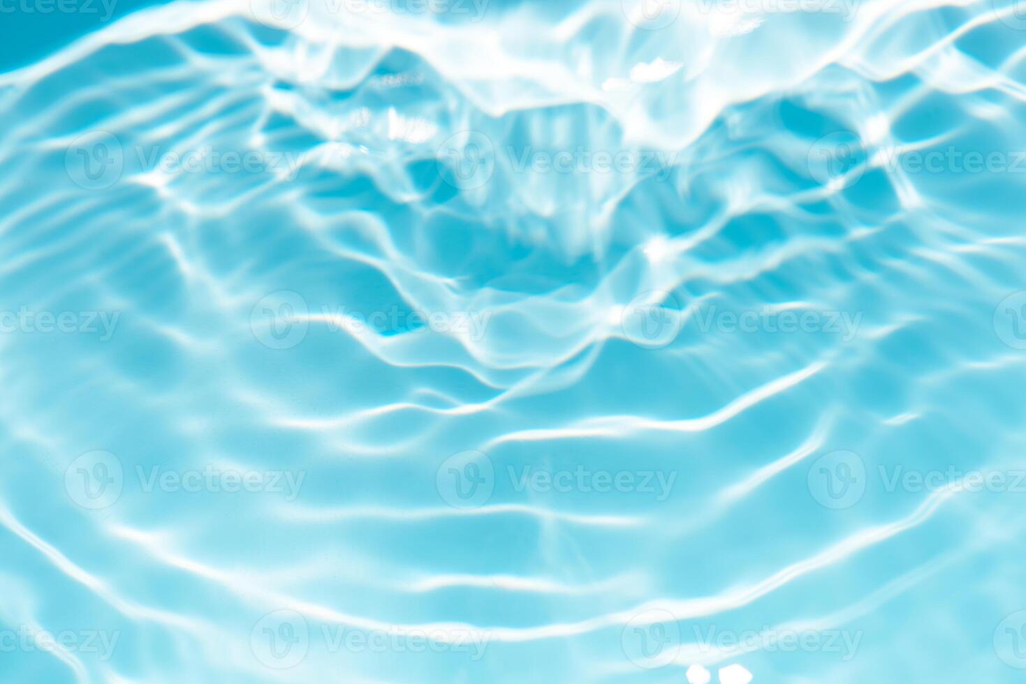 Bluewater waves on the surface ripples blurred. Defocus blurred transparent blue colored clear calm water surface texture with splash and bubbles. Water waves with shining pattern texture background. photo