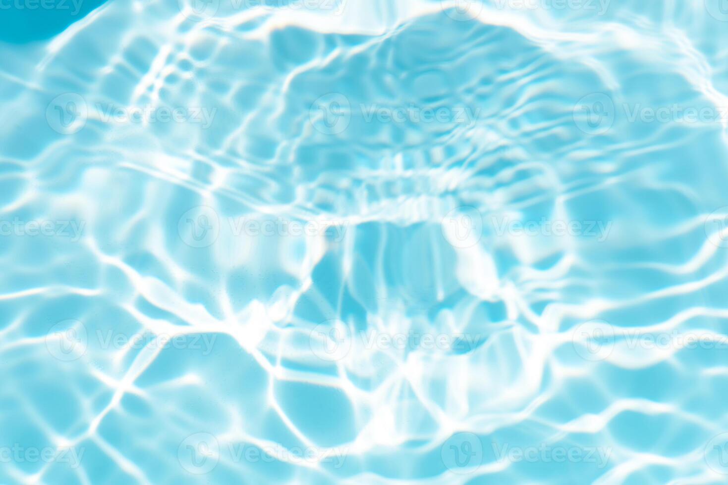 Bluewater waves on the surface ripples blurred. Defocus blurred transparent blue colored clear calm water surface texture with splash and bubbles. Water waves with shining pattern texture background. photo