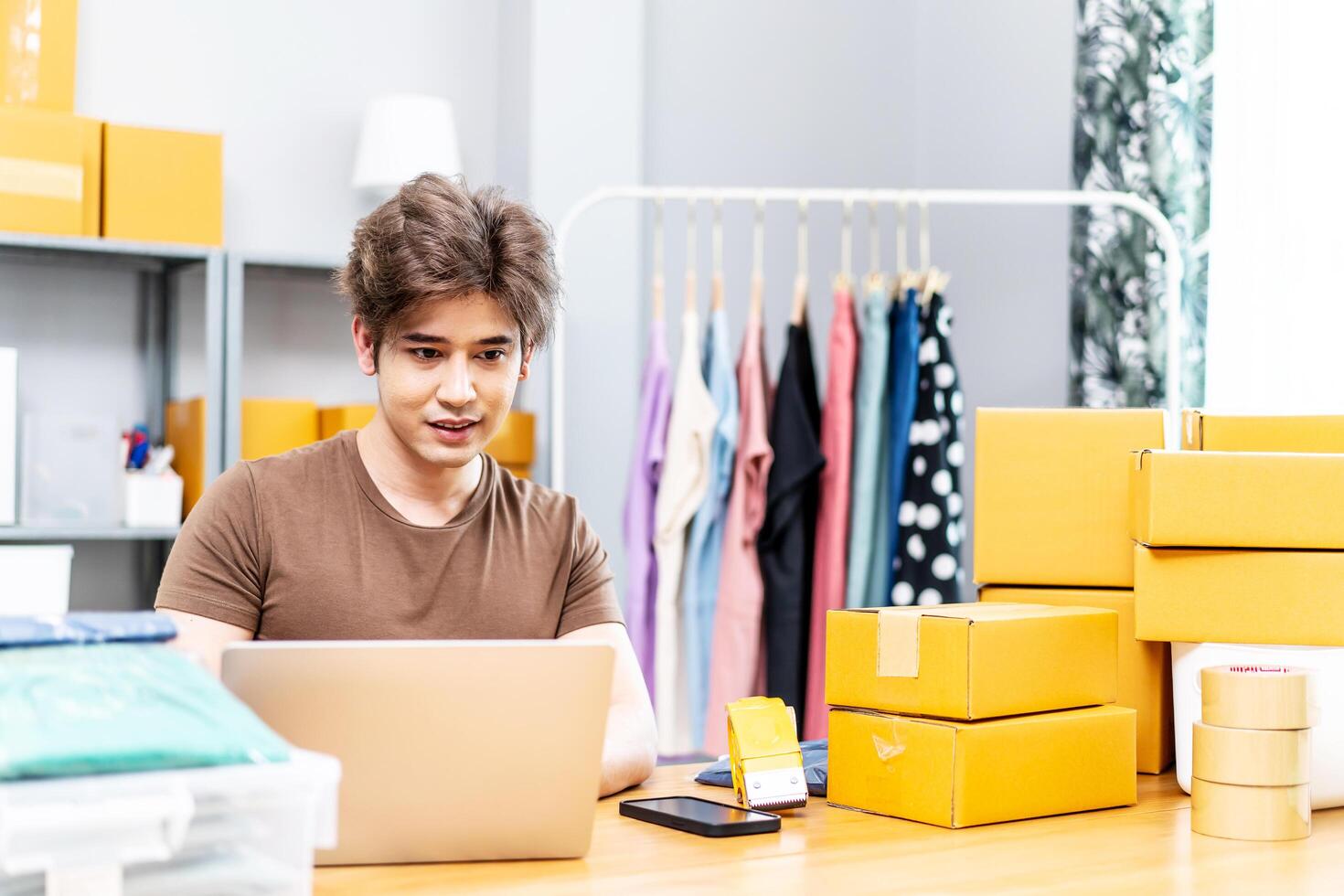 Entrepreneurs Small Business SME freelance working in home office using computer laptops for commercial checking, online marketing, packing boxes, SME sellers, concept, e-commerce team, online sales photo