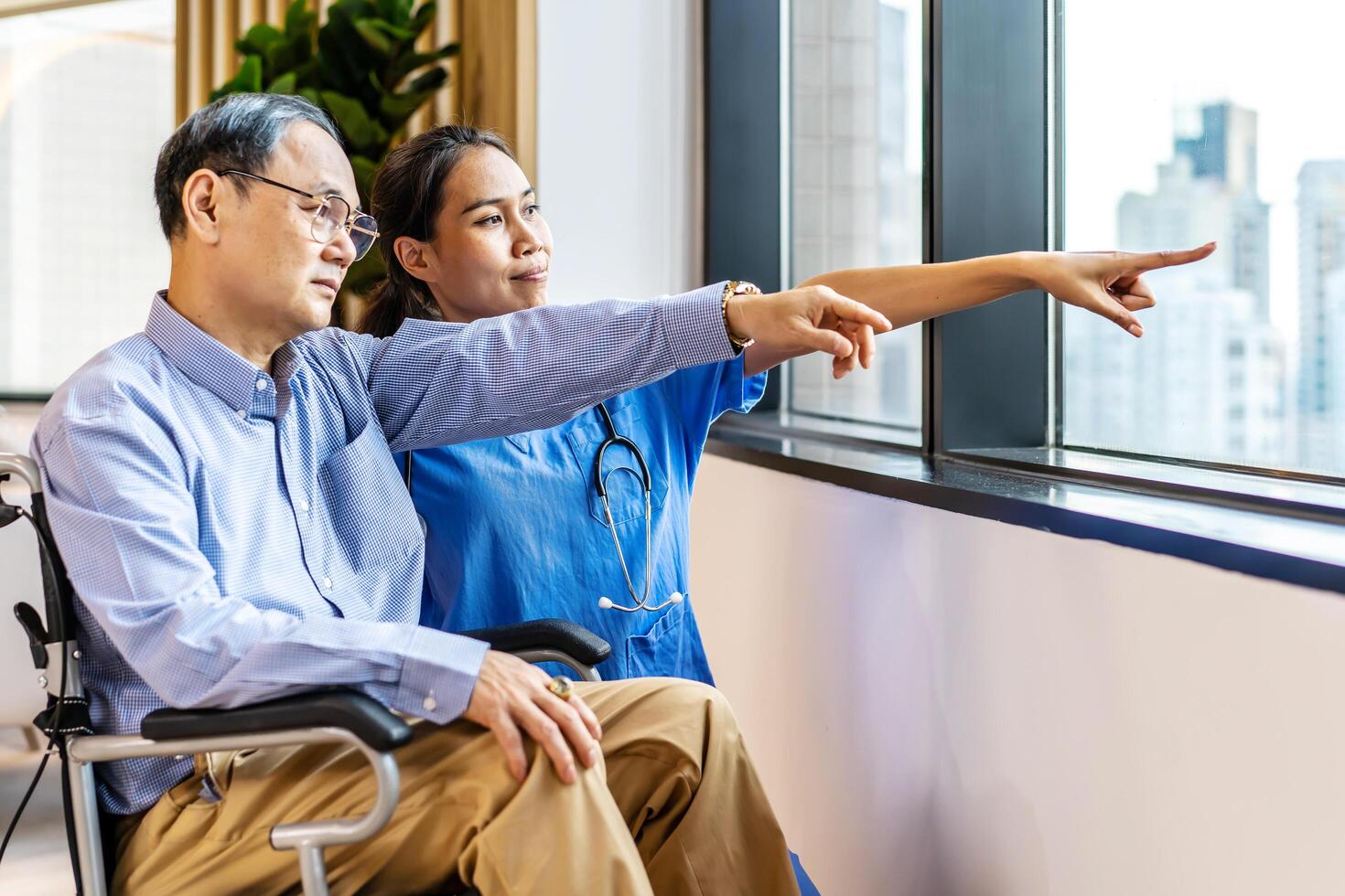 Asian female doctor or nurse treats elderly patient suffering from depression he was sitting in a wheelchair. The concept of senior patients, depressive disorders in the elderly. senior health care photo