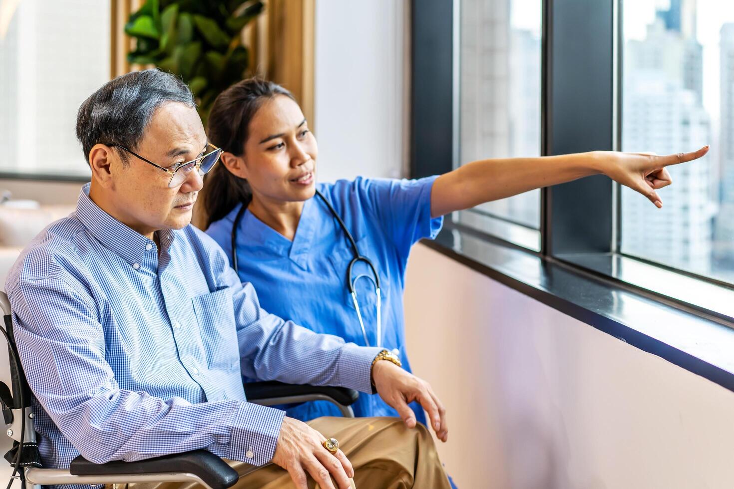 Asian female doctor or nurse treats elderly patient suffering from depression he was sitting in a wheelchair. The concept of senior patients, depressive disorders in the elderly. senior health care photo