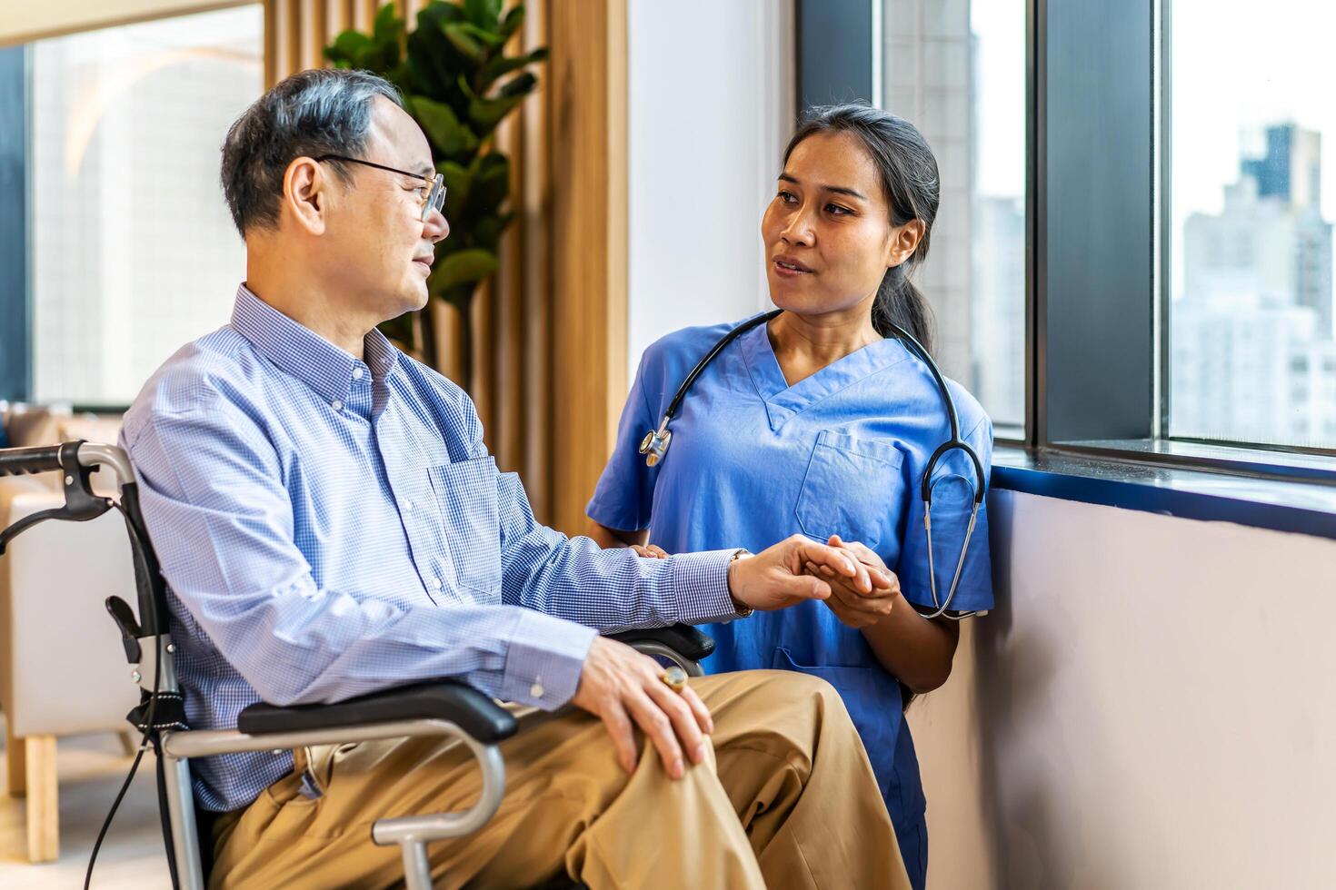 Asian female doctor or nurse treats elderly patient suffering from depression he was sitting in a wheelchair. The concept of senior patients, depressive disorders in the elderly. senior health care photo