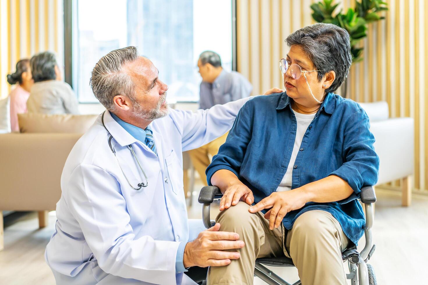 Professional doctor talk and encourage to elderly woman hand who sitting on the wheelchair at hospital, Caregiver provide care medical service help support smiling old grandma at home care medical photo