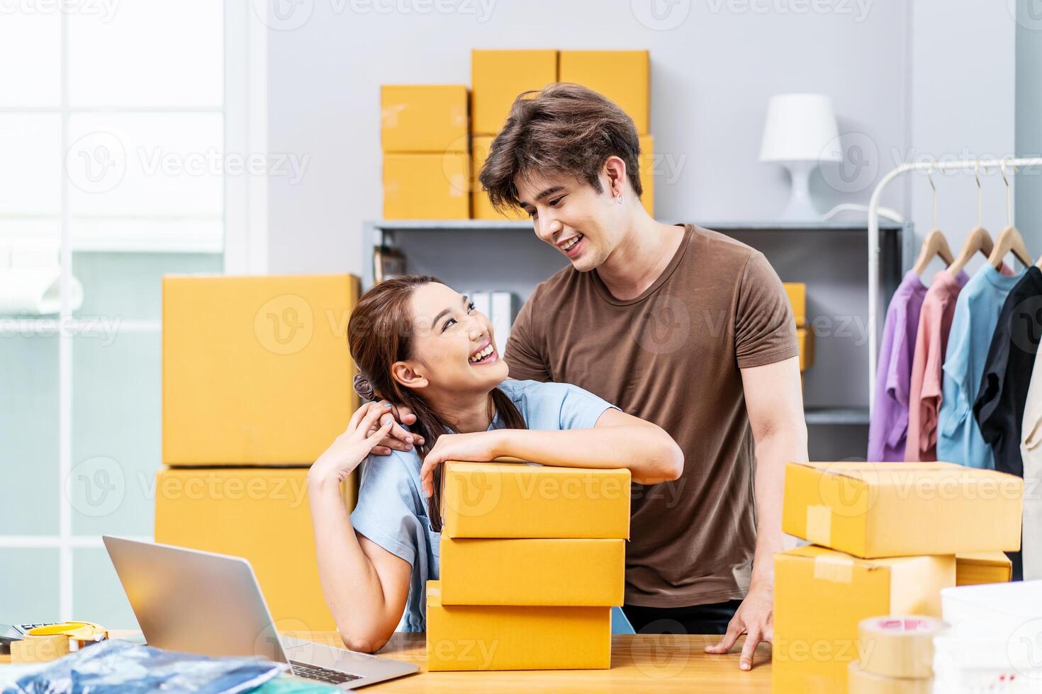 Young Asian couple business working in house office look like doing startup business and smiling happy and positive,Surprise of couple success on making big sale of his online store. photo