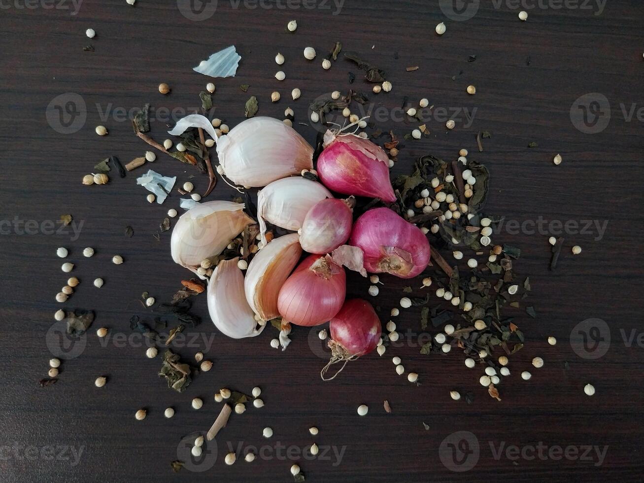 shallots and garlic sprinkled with coriander and dried tea leaves photo