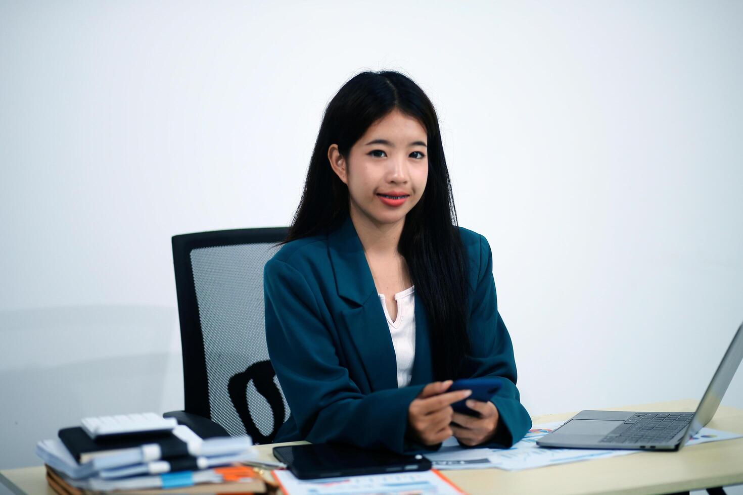 Attractive asian woman using a laptop PC and a smart phone. photo