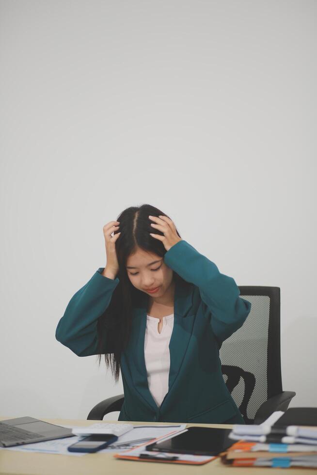 Stressed female worker and business woman holding a pile of paperwork while getting more work to do. Looking frustrated in camera, isolated on white background. Concept Too much work photo