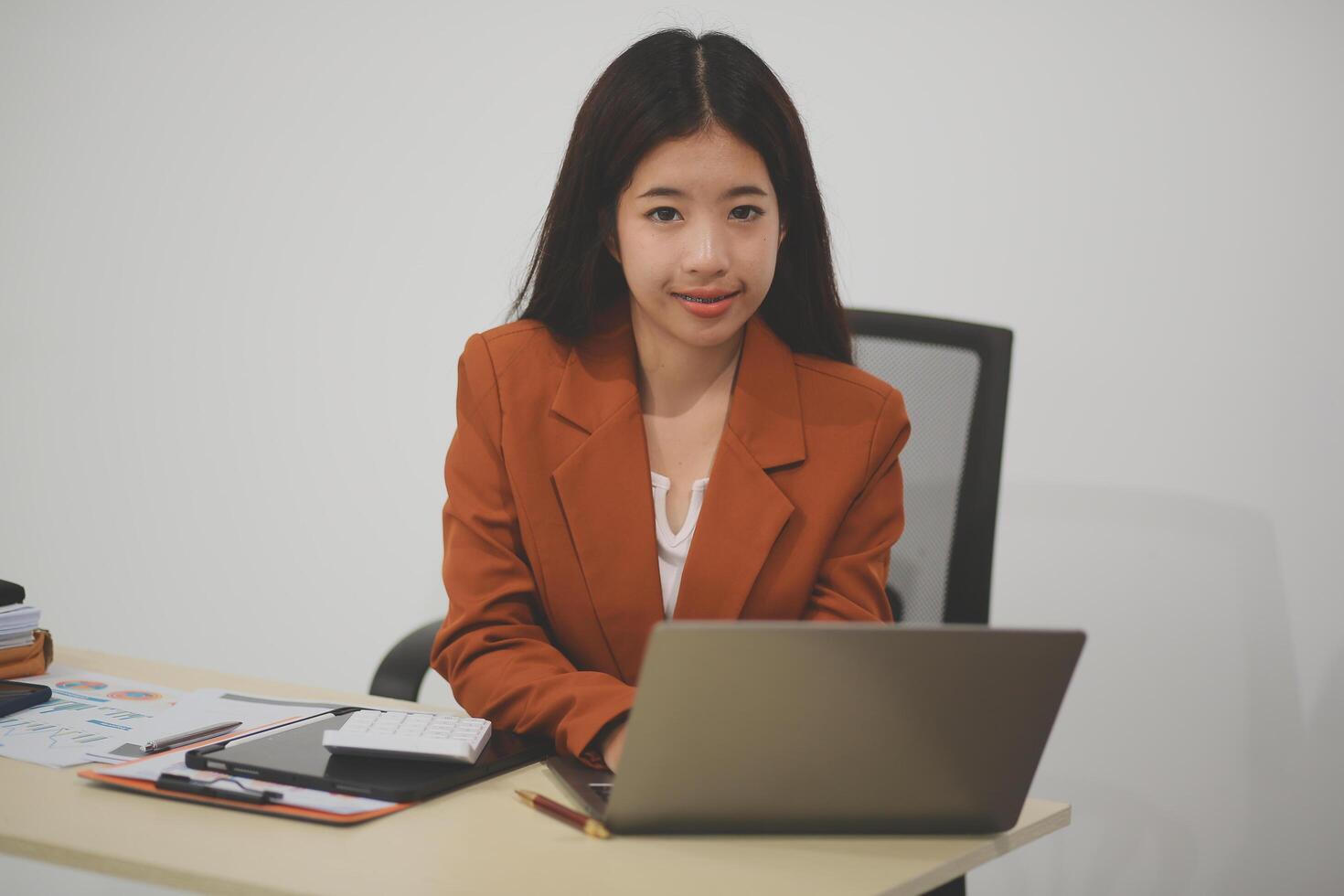 A driven and dedicated young professional showcases her efficiency and attention to detail as she works diligently on her laptop photo