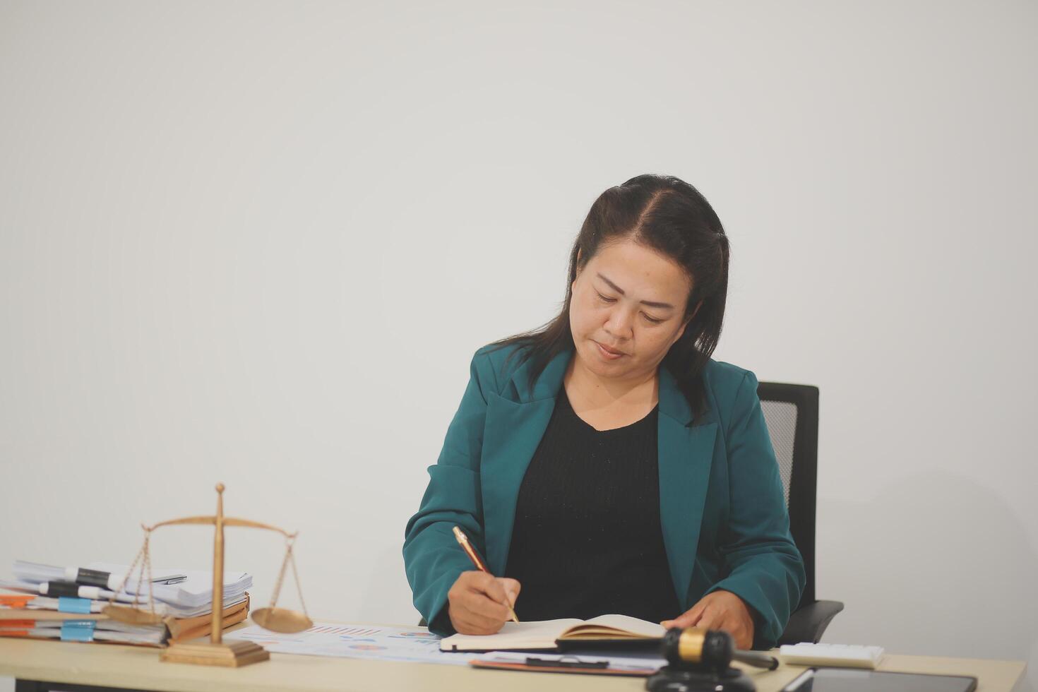 Pretty Asian female lawyer working and hammer, laptop, justice advice and legal concept. In office photo