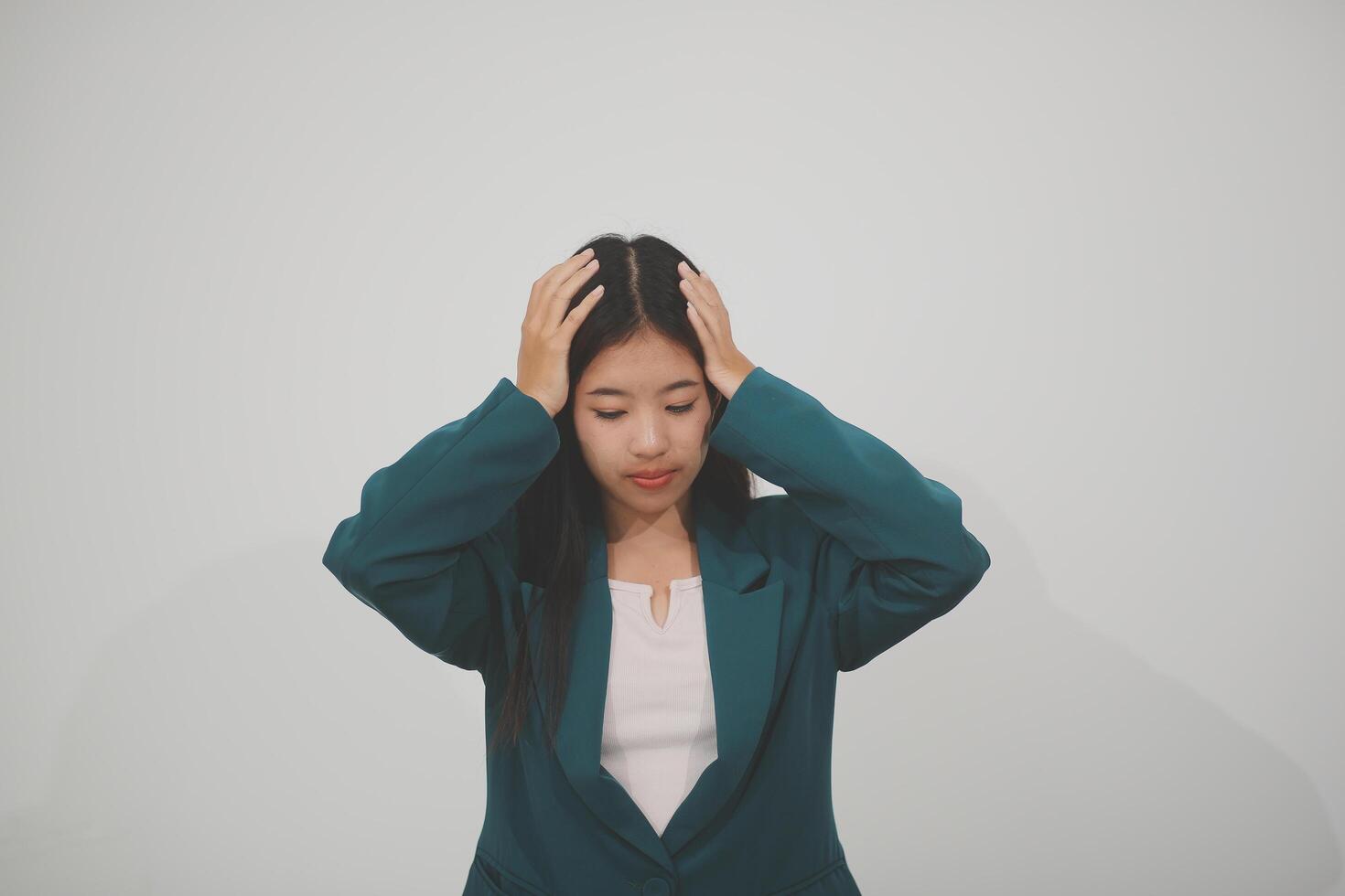 Stressed female worker and business woman holding a pile of paperwork while getting more work to do. Looking frustrated in camera, isolated on white background. Concept Too much work photo