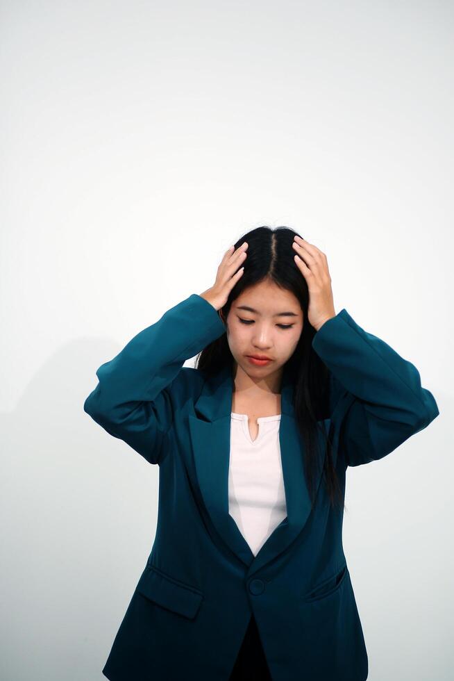 Stressed female worker and business woman holding a pile of paperwork while getting more work to do. Looking frustrated in camera, isolated on white background. Concept Too much work photo